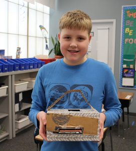 A Wolf student shows off his latest invention on Kid Inventor Day!